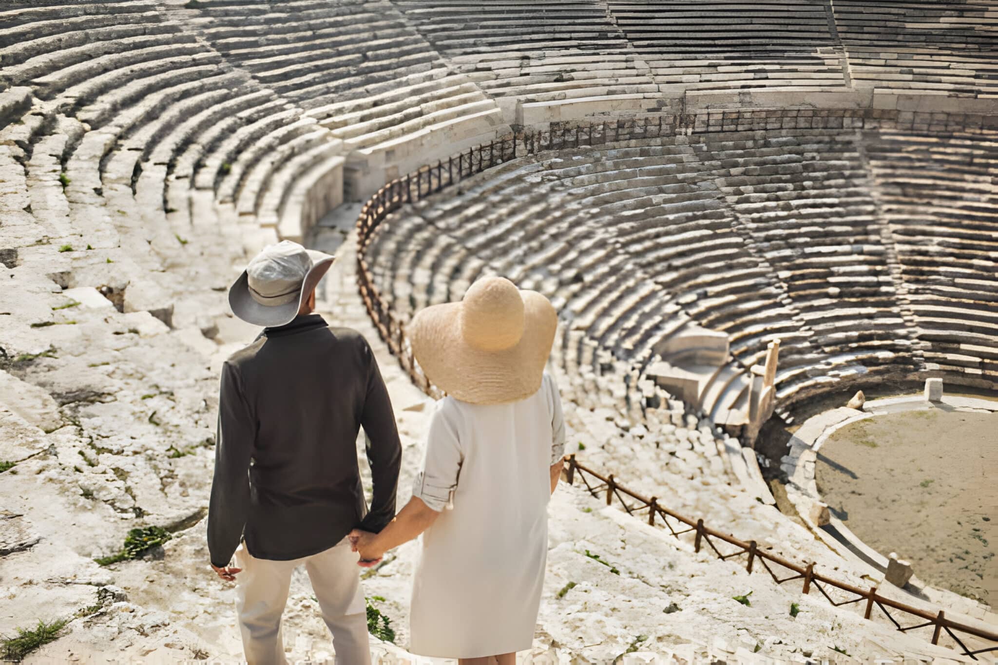 Mature couple in love overlooking old stone theater.